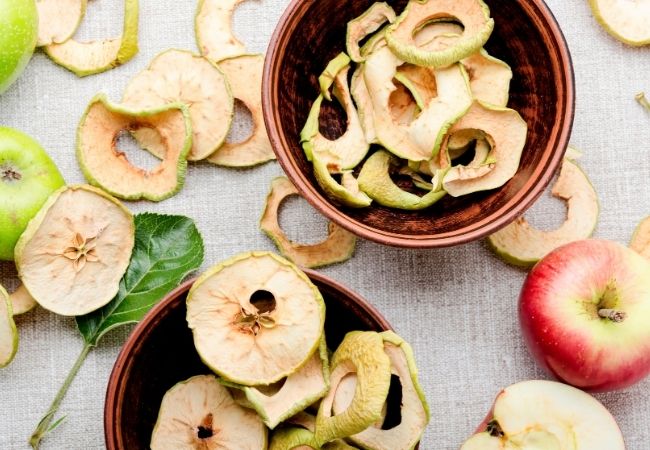 Dried apple slices with apples and apple leaves - creative ways to save money with dehydrator 